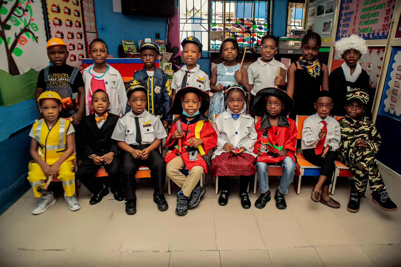 Nursery pupils dressed for Career Day, seated together in their classroom