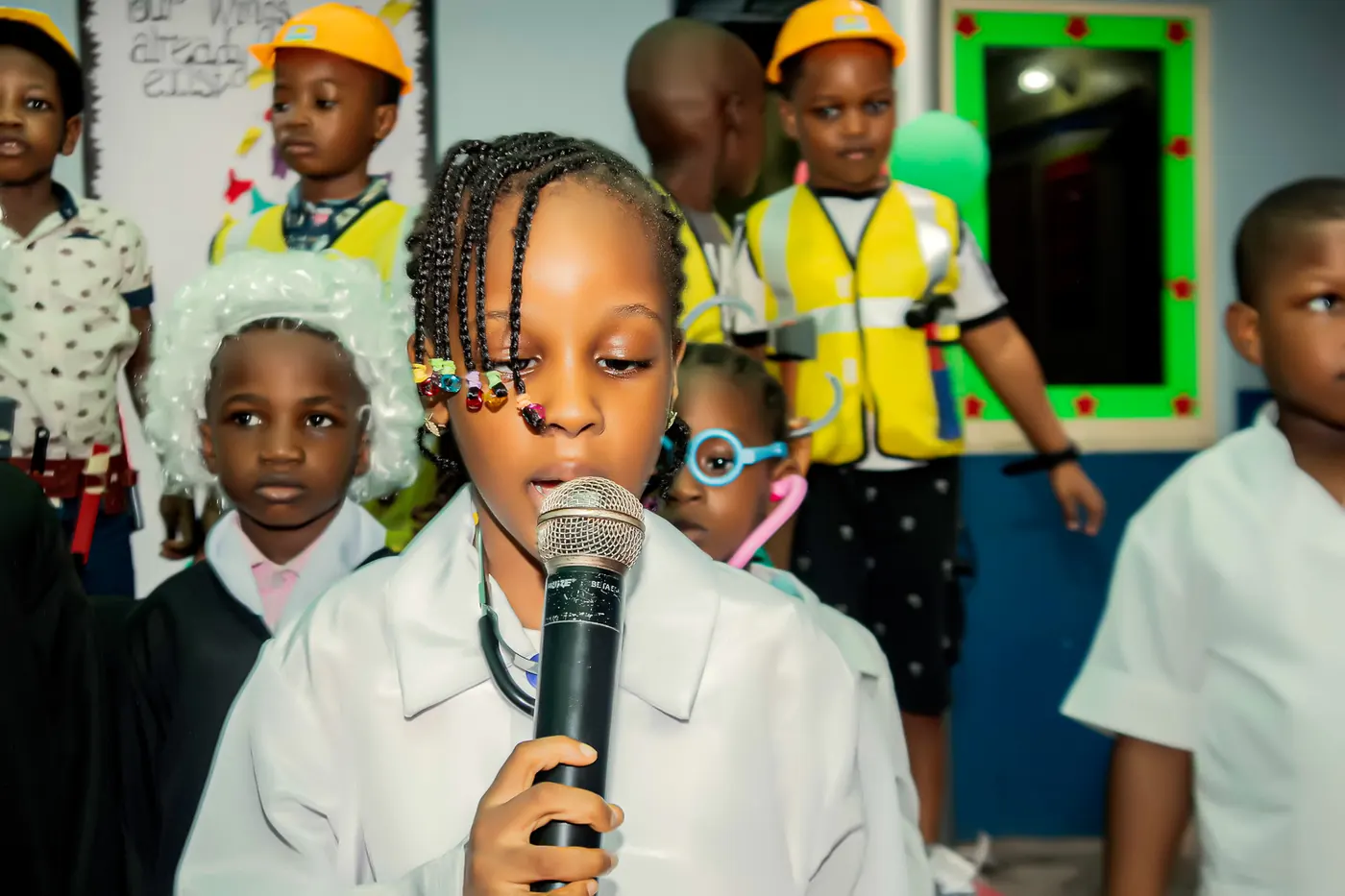 A pupil in a doctor’s coat speaking at Career Day