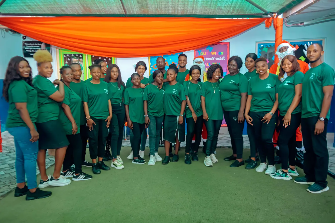 The Chasteville team gathered together in matching green school T-shirts