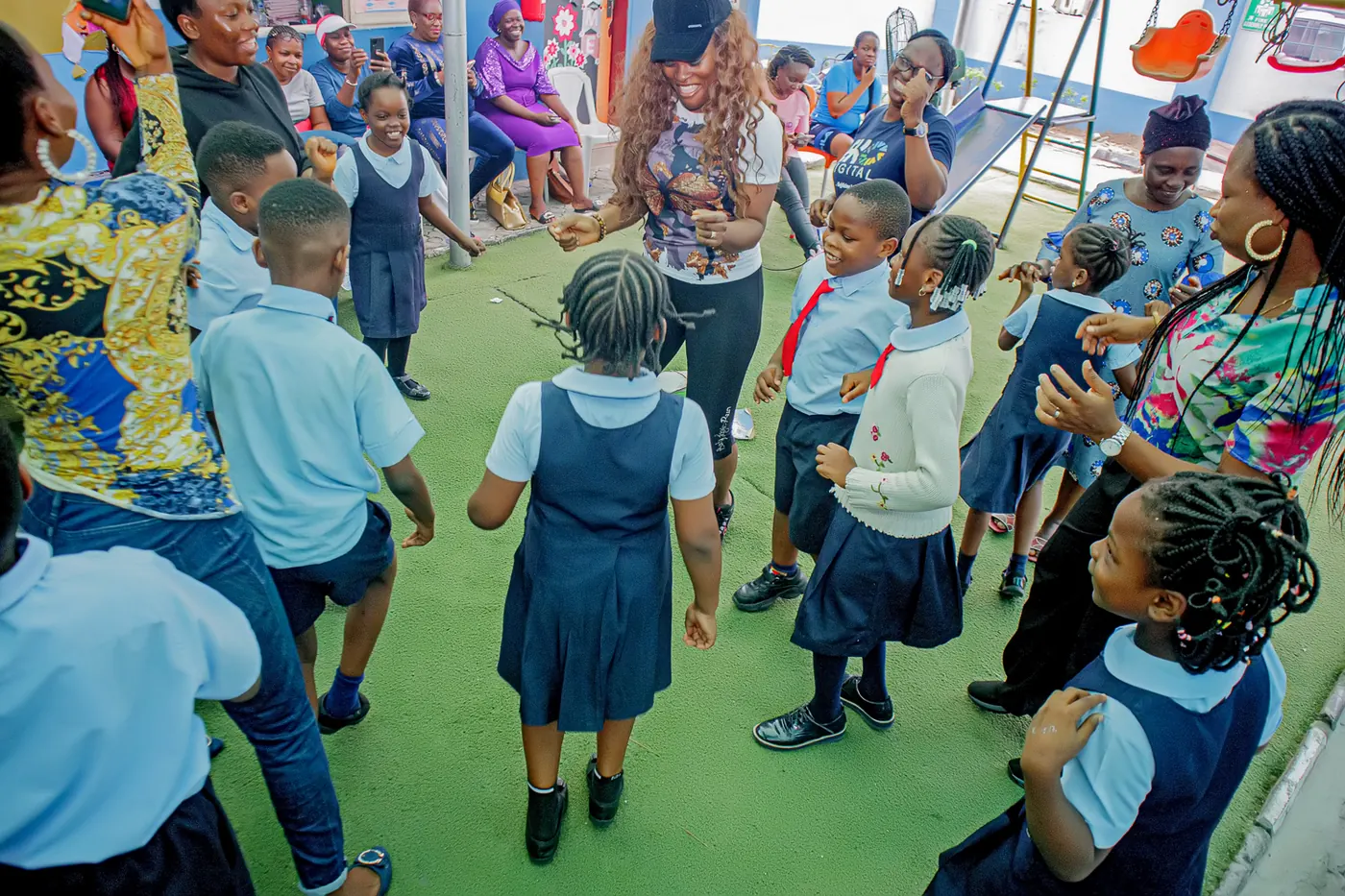 Pupils dancing together on the playground at a school celebration